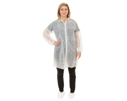 Person wearing a white disposable lab coat on a white background