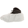 White shoe cover over a black shoe on a white background