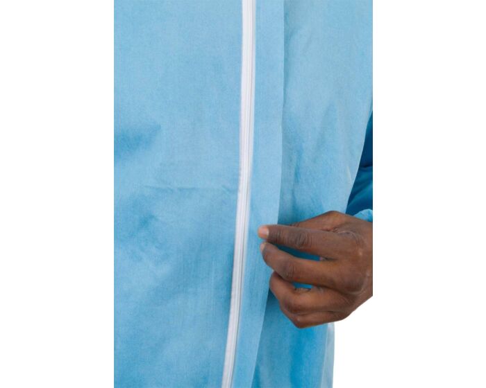 Person wearing a blue medical gown with a white pole, likely in a hospital setting.